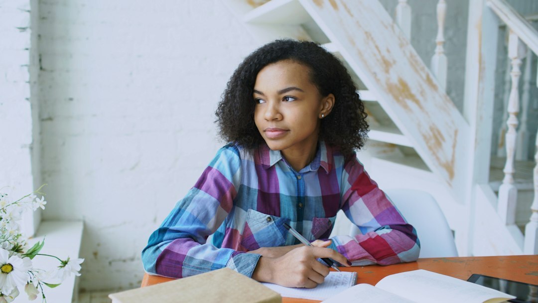 writer at desk with books