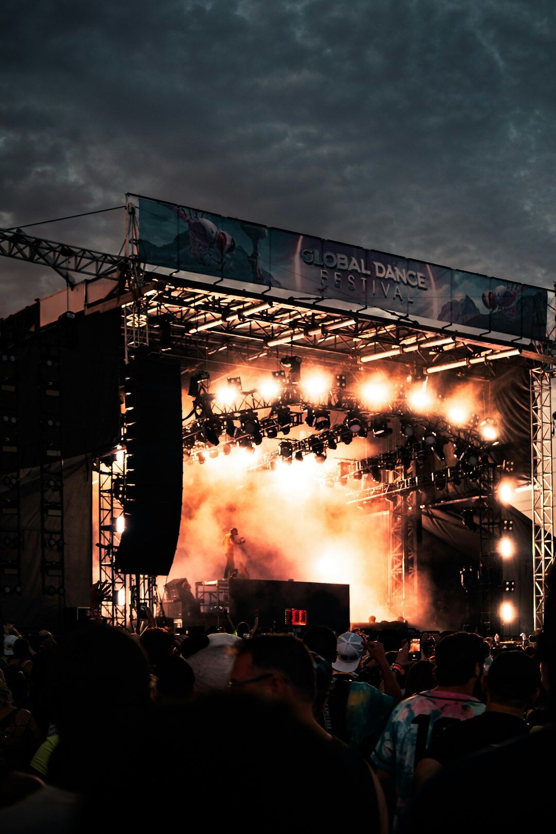 Outdoor music festival stage with colorful lights